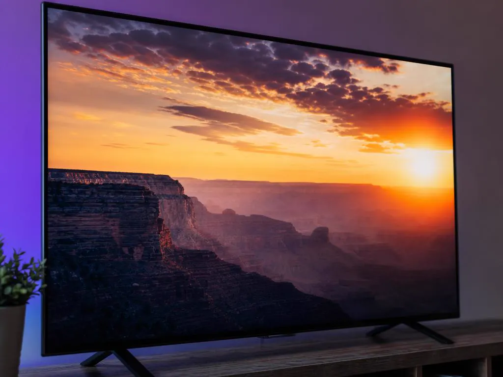 Close-up of a TV showing a bright sunset with deep shadows, demonstrating HDR contrast