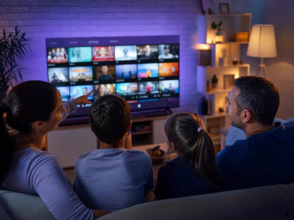 Family browsing a TV guide grid together on a big TV