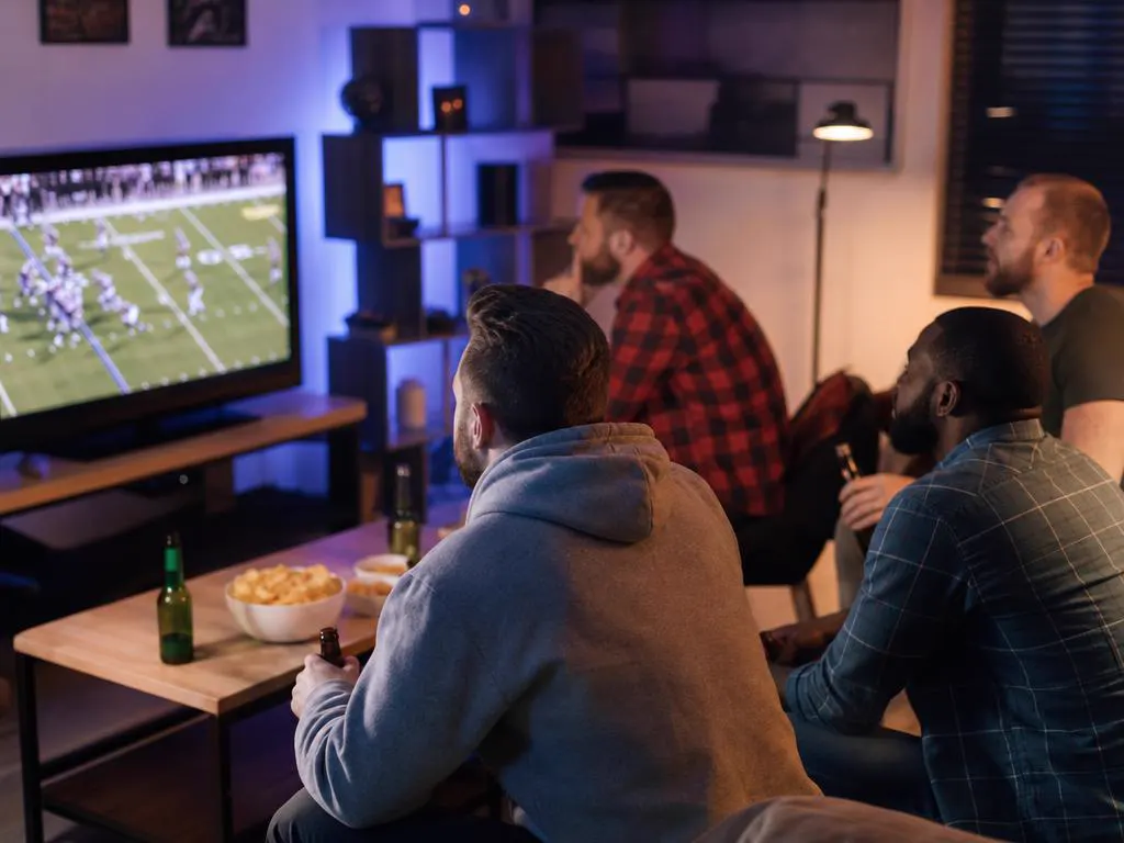 Friends watching a live game during a free trial evening