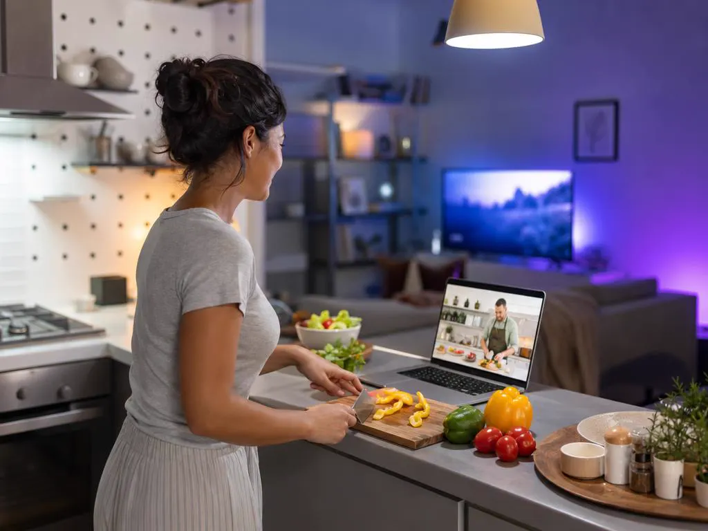 Laptop on a kitchen counter showing a cooking show